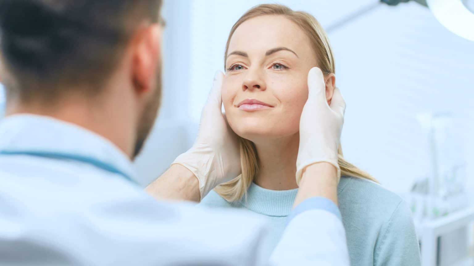 Before Face Lift Consultation Plastic Surgeon Examines Woman for Face Lift