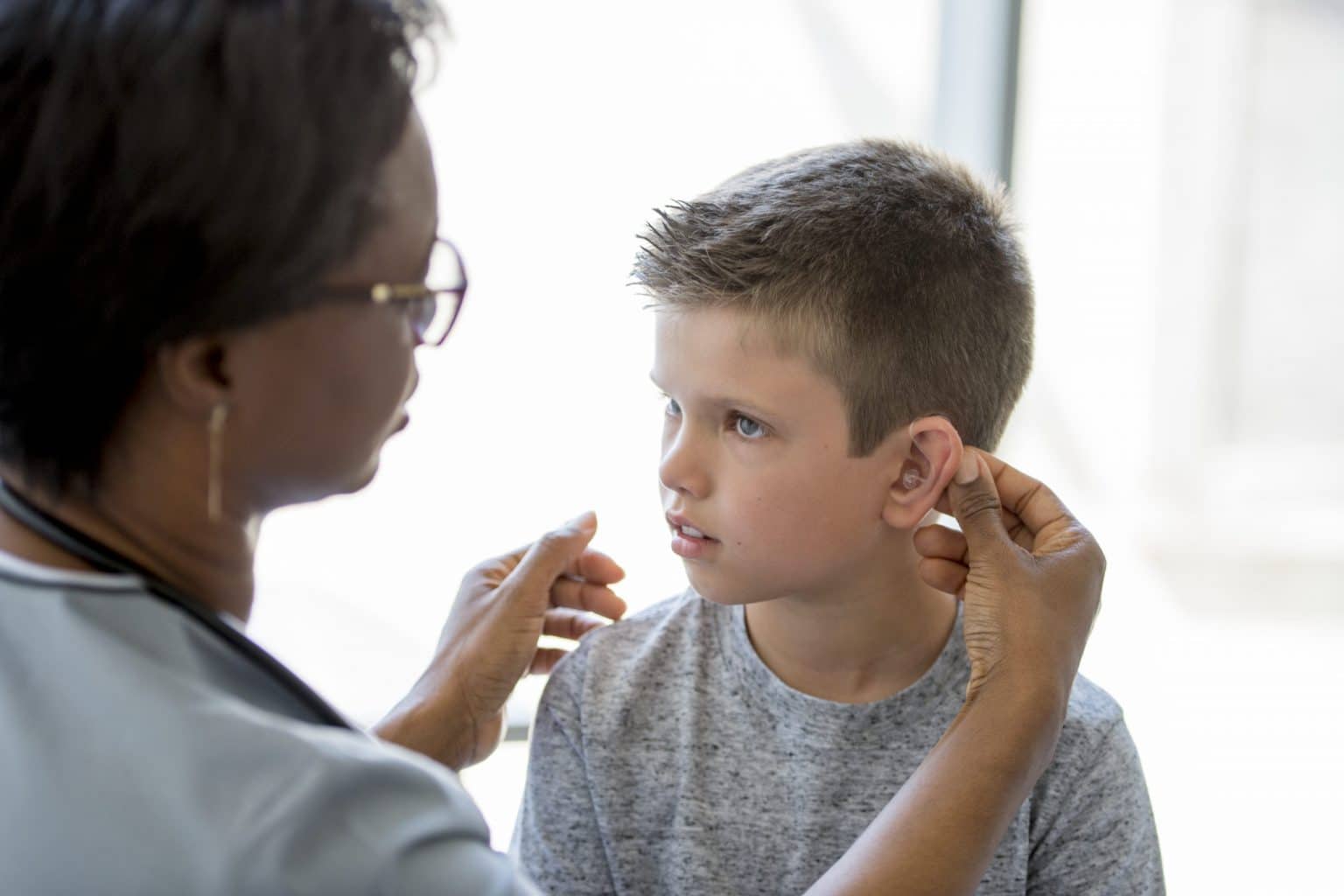 Pediatric Child Hearing Aid Fitting Child With Hearing Aid Receiving Hearing Checkup From Audiologist